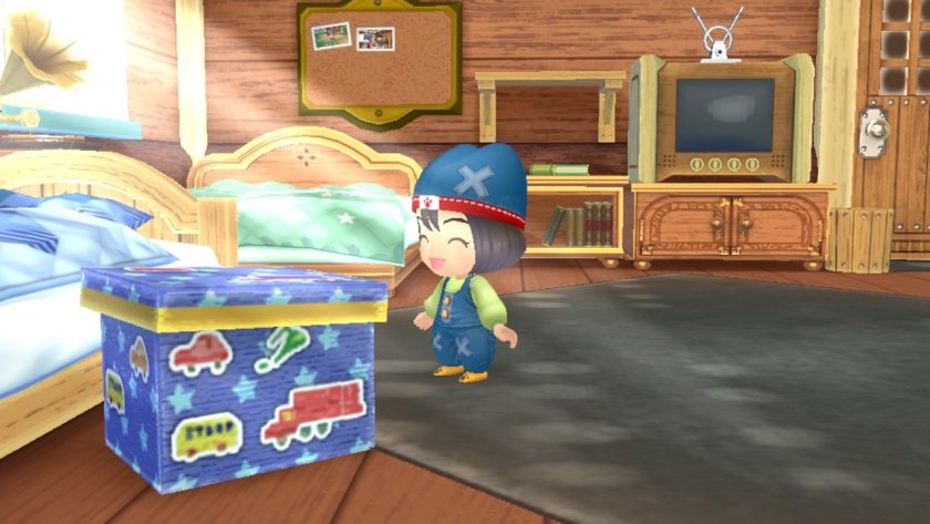 A little child stands near a toy box in the farm house