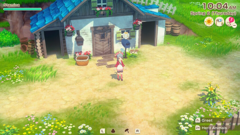 A screenshot from Story of Seasons: Grand Bazaar shows a young girl standing outside a charming farmhouse with a blue-tiled roof, surrounded by green grass and colourful wildflowers. The on-screen interface displays the date as Spring 6 (Thursday) at 10:04 AM. The girl wears a red beret, red jacket, and white dress, and stands on a sunlit dirt path. The farmhouse features flower boxes, barrels, a mailbox with a chicken sign, and a white picket fence in the background. Published on: LadiesGamers.