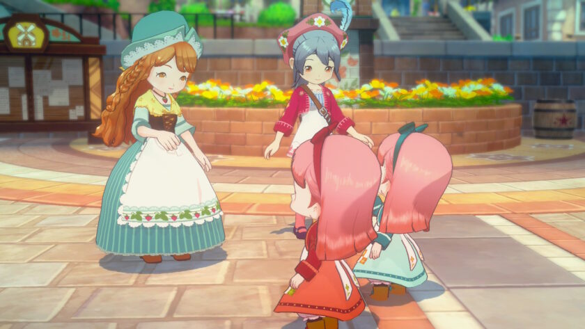 A screenshot from Story of Seasons: Grand Bazaar shows two adult characters and three children interacting in a sunny town square. The woman on the left wears a green bonnet and a teal dress with a white apron decorated with pink flowers. The female protagonist stands beside her in a red beret and matching outfit. The three children, all with pink hair and colourful dresses, appear to be playing or greeting the adults. Behind them is a raised flower bed with bright orange blooms and a notice board. The scene is cheerful and lively, highlighting community life in Zephyr Town. Published on: LadiesGamers.